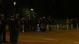 Riot police arrest man during G20 protest at night with flashlights in Hamburg