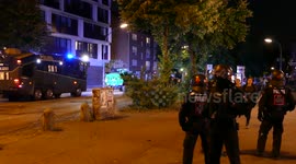 Police convoy with armored vehicles driving through Hamburg streets at G20