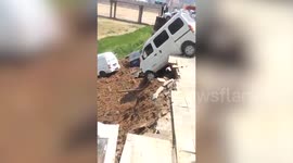 Vehicles plunge when riverbank collapses