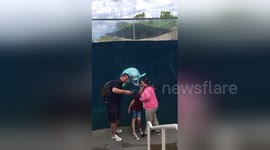 Beluga whale photobombs family