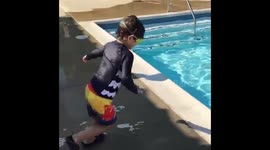 Kid jumping into swimming pool- slo mo