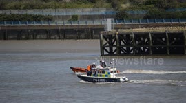 Police, RNLI and Port of London Authority conducting a river search