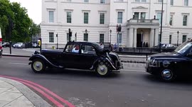Classic car driving through Mayfair in London