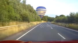 Hot air balloon crosses busy road near Market Harborough