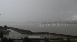 Torrential rain obscuring the view across the river Thames in East London