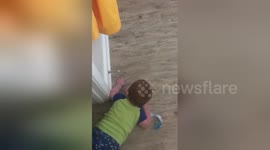 Baby finds spring door stop hilarious