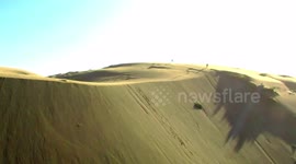 Daredevil sandboards across giant dunes in South Chile
