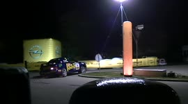 Heavily damged rally car carrying on after crash throwing sparks everywhere