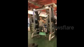 Woman pumps iron while nine months pregnant with twins