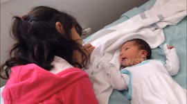 Sister meets her baby brother for the first time