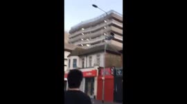 Drunk Guy Climbs A Street Light and Hangs Off It To Impress Friends