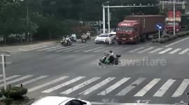 Scooter rider narrowly escapes being run over by lorry