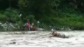 Rescuers save two tourists trapped in flooded river