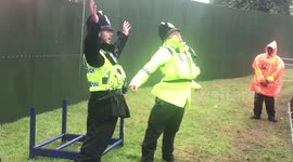 Police officers dance in front of festival-goers at Camp Bestival