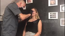 Female gets her nose pierced