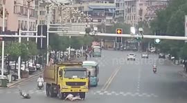 Man crossing road on scooter narrowly escapes being killed by lorry