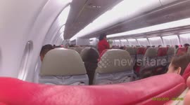 Caring flight attendant tries to calm crying baby