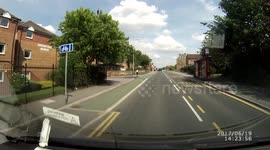 Motorbike wheelie in traffic towards pedestrian crossing