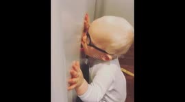 Hilarious baby practices his kissing skills on the refrigerator