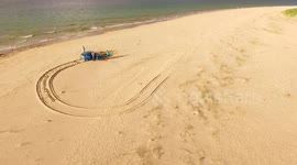 Drone captures car rescue on beach as tide approaches