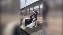 Motorcyclist pulls insane wheelies on busy highway