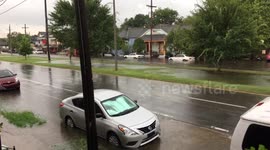 Cars and pedestrians during Heavy flooding on St Claude Avenue New Orleans 9th ward