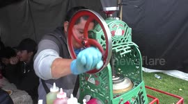 A man using Vintage Cast Iron Swan Ice Shaver to sell ice cream