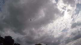 Tandem skydivers get dragged away under parachute in strong winds