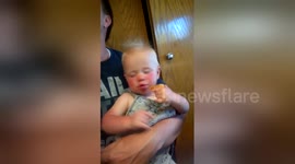 Adorable baby falls asleep while eating pizza