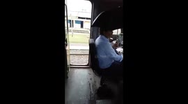 Indian operator sits under umbrella while driving train – says leaking engines are a safety hazard