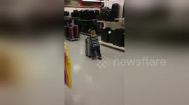 Newsflare Edit - two kids using suitcases as a toys in TK-Maxx