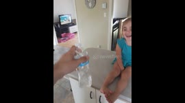 Dad show daughter how to bottle flip