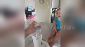 Newsflare Edit - Dad show daughter how to bottle flip
