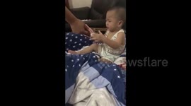 This toddler loves money