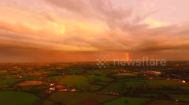 Drone Flies Towards Rainbow & Sunset Clouds