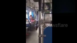 Bus driver performs pull ups at traffic lights