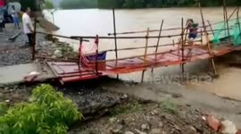 Foot bridge collapses moments after woman crosses it