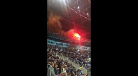 Russian football fans light flares at match