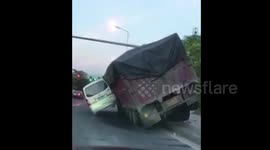 Two vehicles get stuck in bizarre position after collision