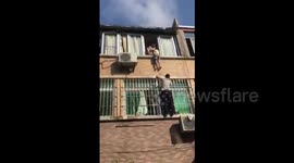 Neighbours rescue girl hanging from second-floor window