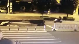 Huge sinkhole opens up swallowing scooter rider