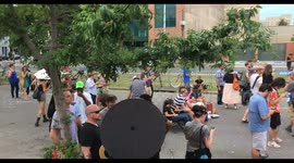 Pan shot of crowd gathering to watch confederate General Lee  monument removal
