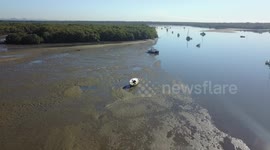 Ariel footage of a beached boat at low tide