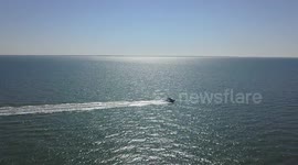 Drone footage of speedboat in ocean