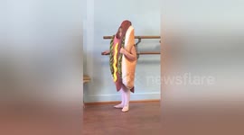Little girl attends ballet class dressed as a hotdog