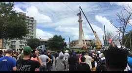Crowd watches as crane approaches to remove Robert E Lee confederate statue