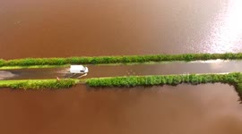 Drone Captures Van Driving Through Flooded Road