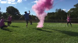Family kick football to reveal baby's gender