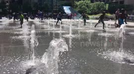 Children play in water spouts