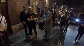 Sienna Miller signs autographs in Grenfell Tower tribute shirt